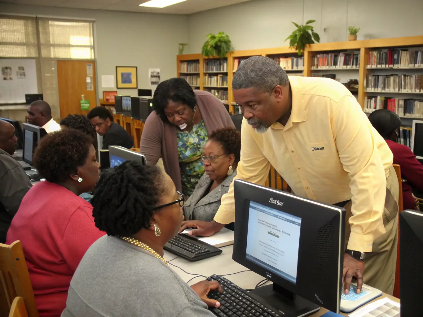 A photograph showcasing adults attending a digital literacy workshop at the Beneventine Municipal Library, focusing on computer skills and internet safety.